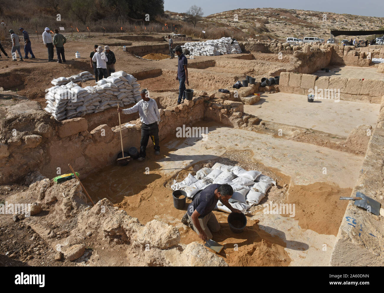Ramat Beit Shemesh, Israel. 23rd Oct, 2019. Workers of the Israel Antiquities Authority clean a mosaic floor in a 1,500 year old Byzantine church in Ramat Beit Shemesh, on Wednesday, October 23, 2019. The three years excavations uncovered the church, Greek inscriptions, mosaics, a baptismal and a crypt of an unknown glorious martyr. Photo by Debbie Hill/UPI Credit: UPI/Alamy Live News Stock Photo