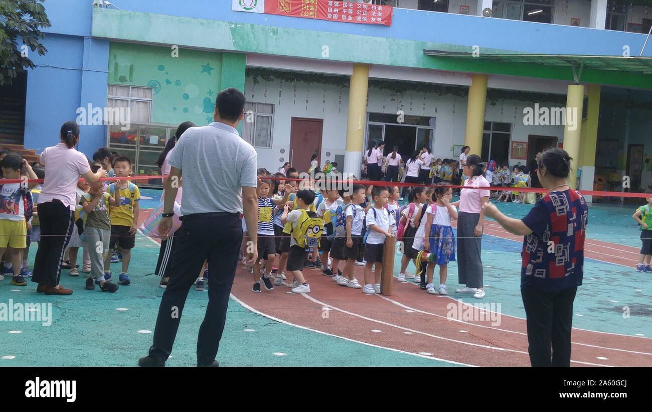 Shenzhen, China: parents pick up their children on the playground after ...