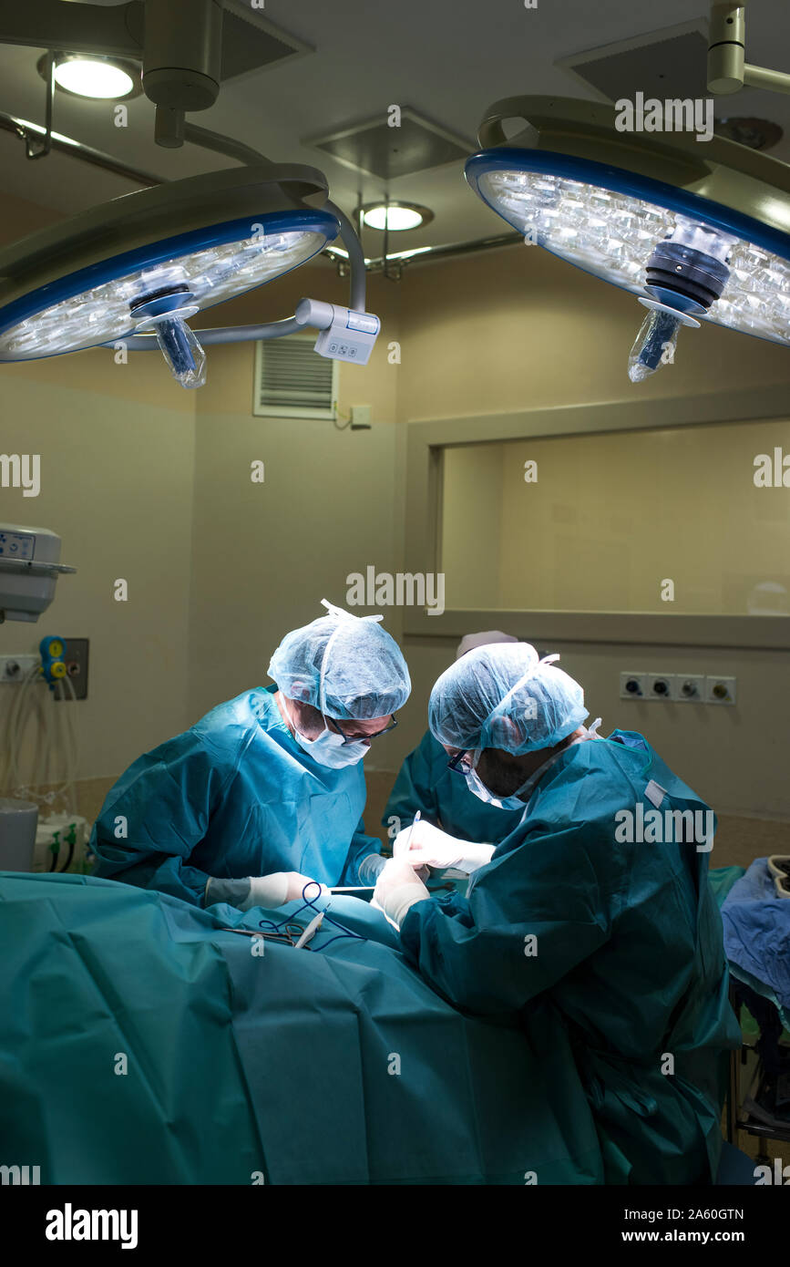 Surgeons and nurse during a foot surgery Stock Photo