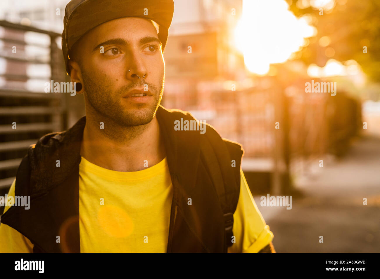 Portrait of pierced young man at backlight Stock Photo