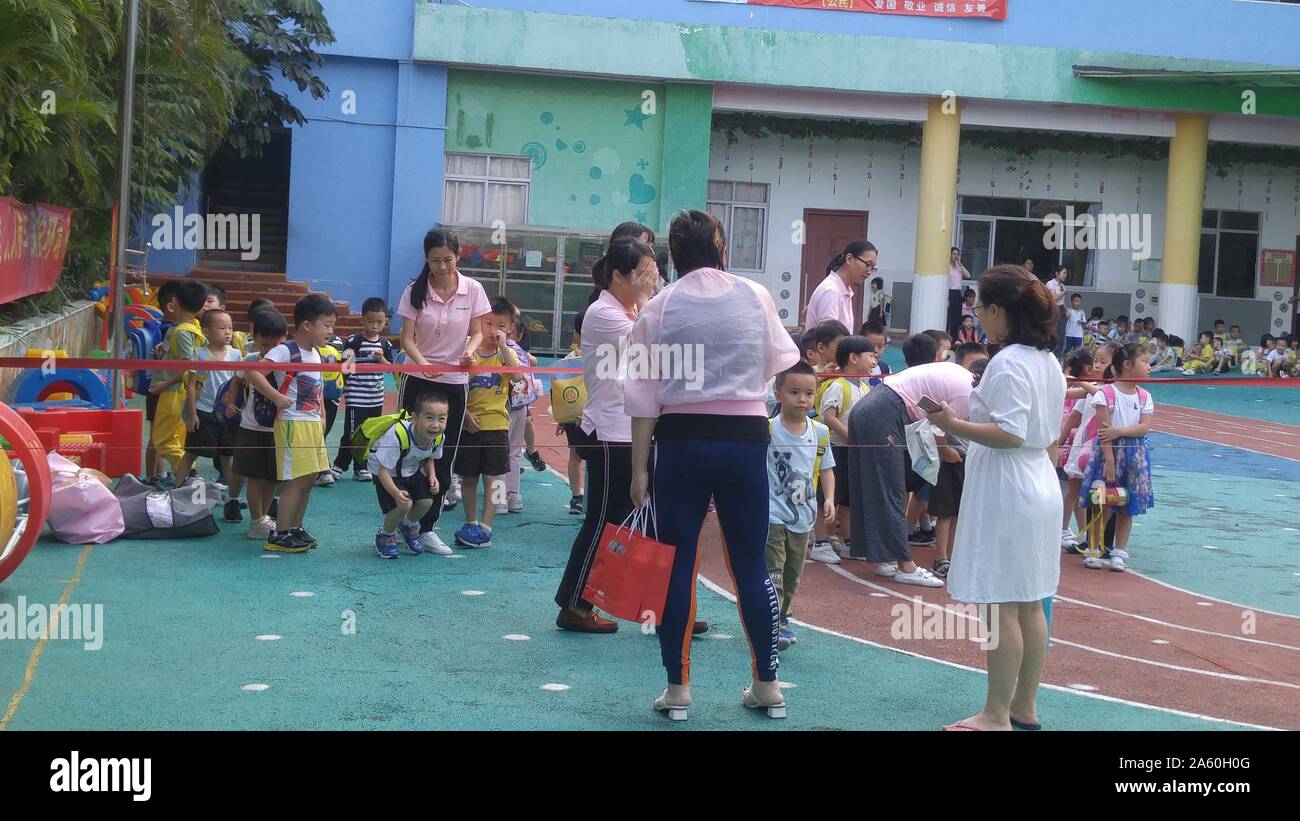 Shenzhen, China: parents pick up their children on the playground after ...