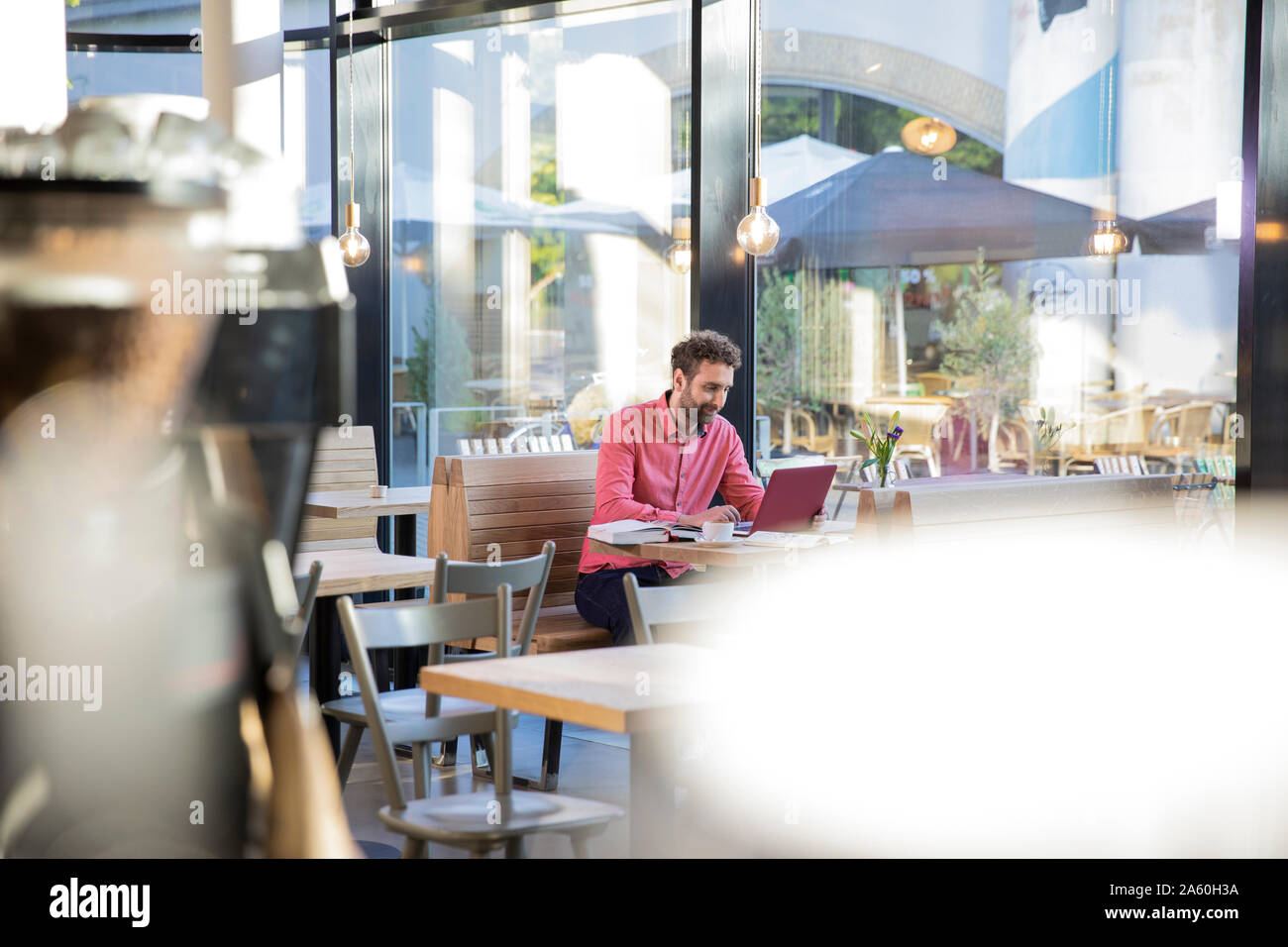 Young man using laptop in a cafe Stock Photo