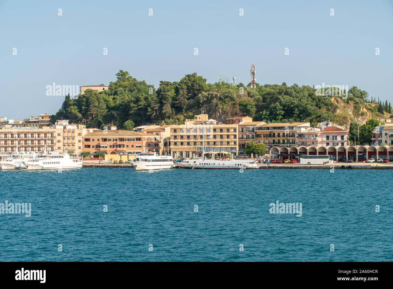 Ships moored at harbor against clear sky in Corfu, Greece Stock Photo