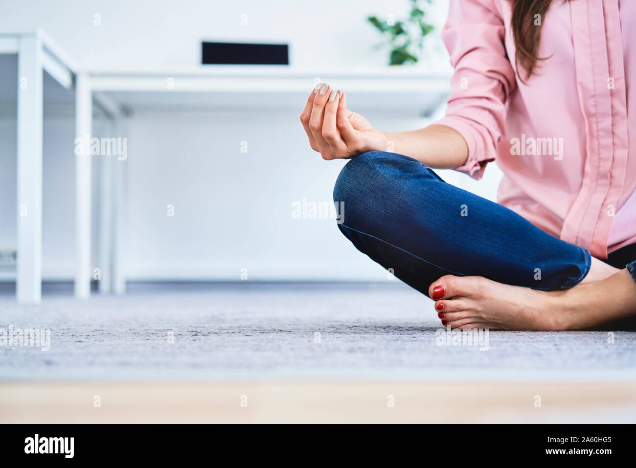 Close up of woman meditating in office Stock Photo