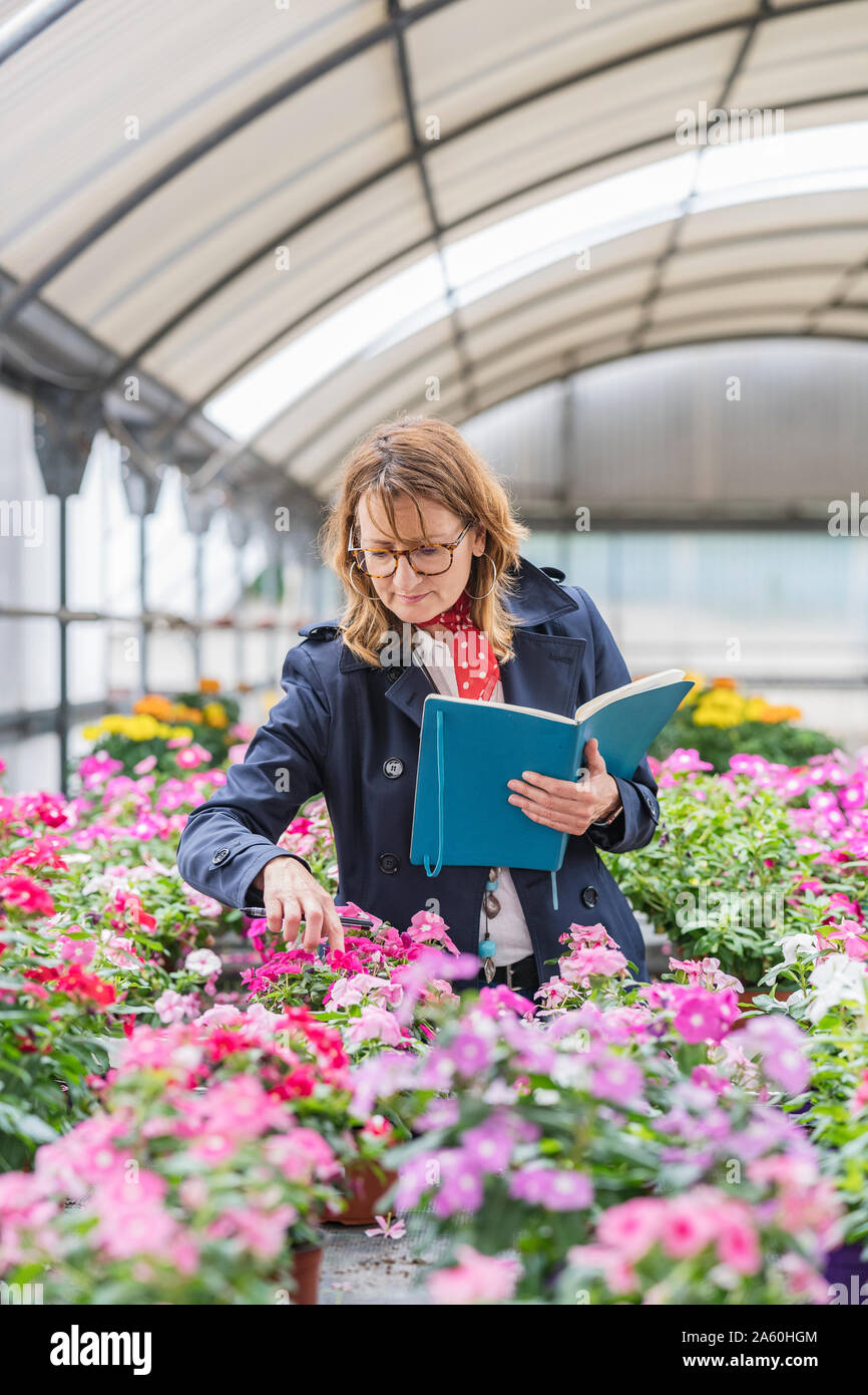 Female manager working in a plant nursery Stock Photo Alamy