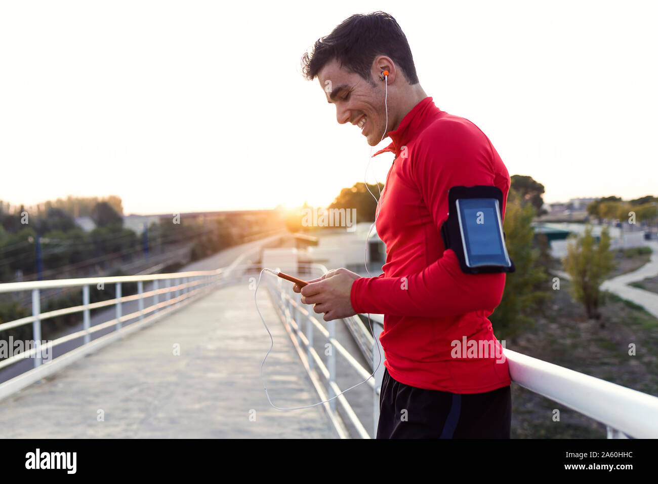 Jogger with smartphone in arm pocket Stock Photo