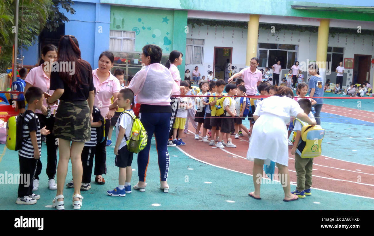 Shenzhen, China: parents pick up their children on the playground after ...