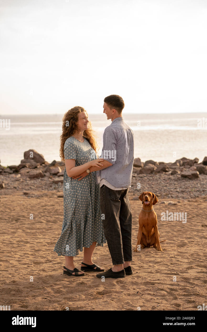 Young couple with dog at the beach Stock Photo - Alamy