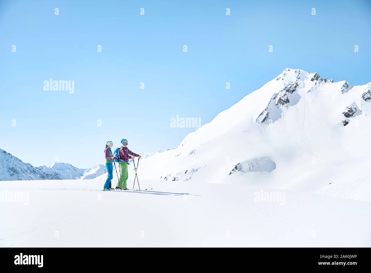 Couple of ski tourers having a break in the mountains, Kuehtai, Tyrol, Austria Stock Photo