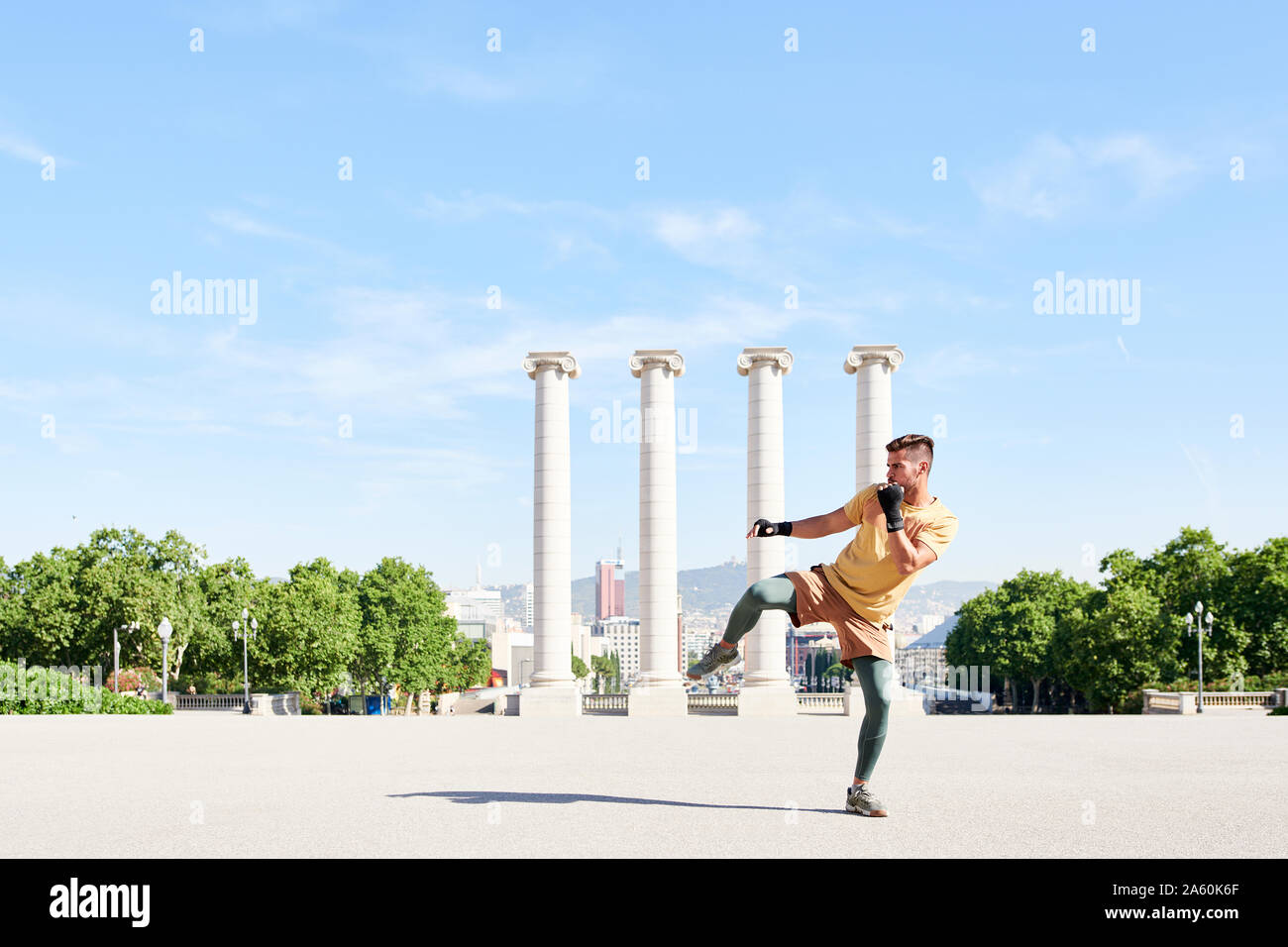 Man doing kickboxing exercise outdoors in the city Stock Photo