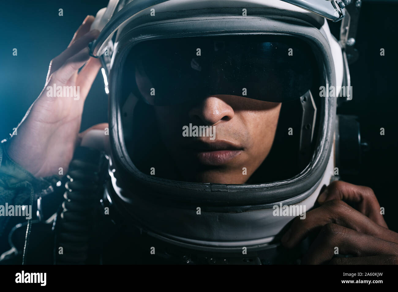 Man posing dressed as an astronaut in skyrocket elevator Stock Photo