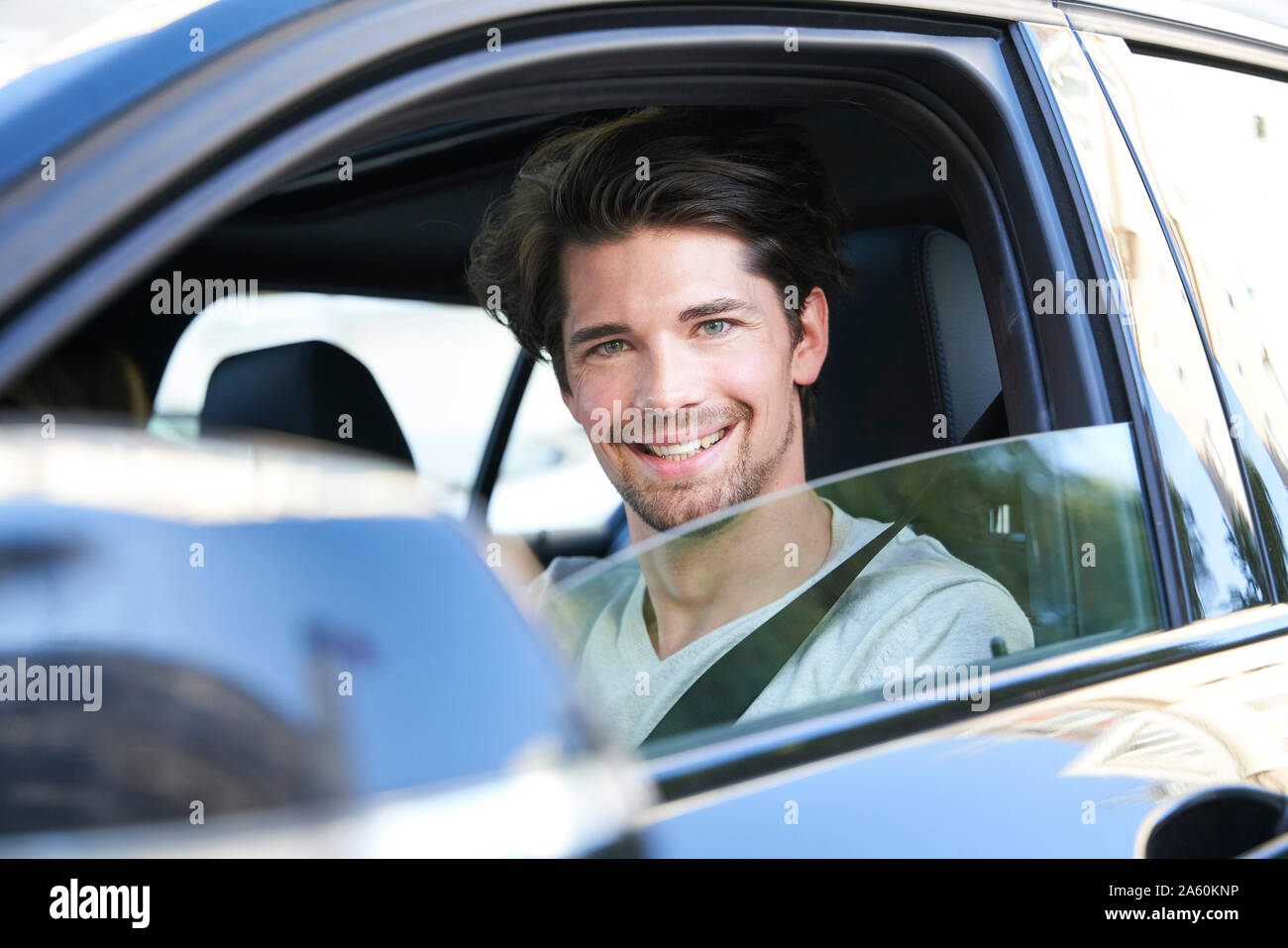 Portrait of smiling man driving car Stock Photo - Alamy