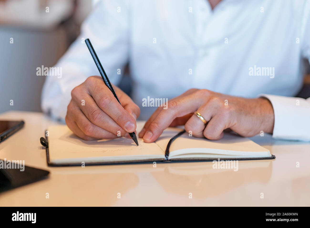 Close-up of businessman taking notes Stock Photo