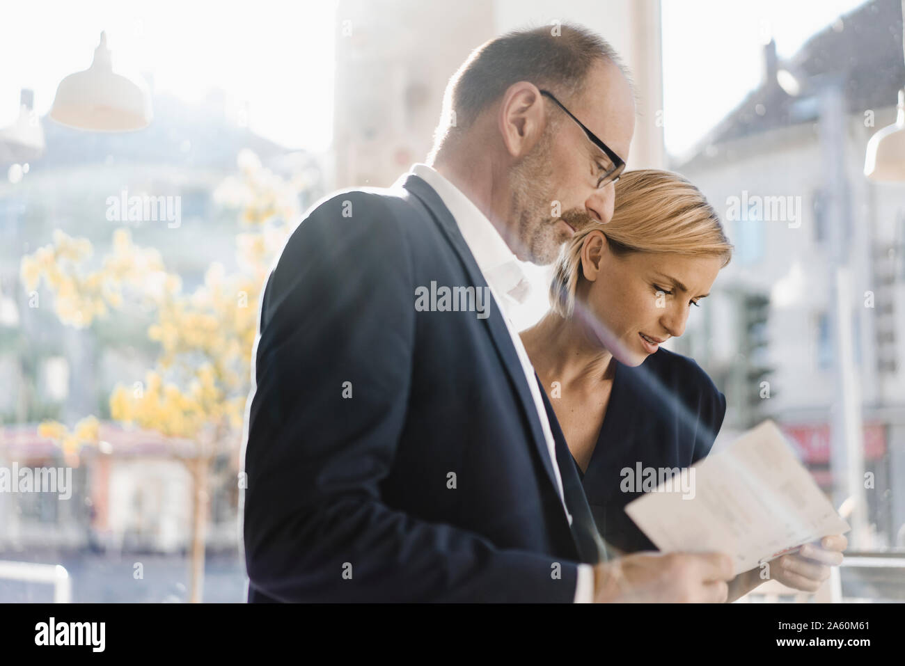 Businessman and woman reading menu in a coffee shop Stock Photo