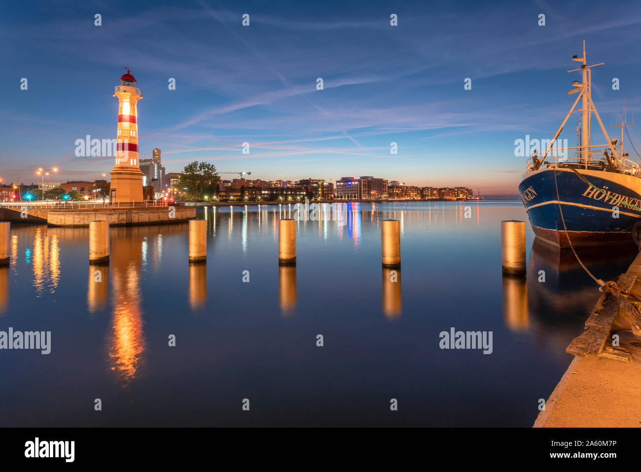 Illuminated lighthouse by river against sky at Malmo, Sweden Stock Photo