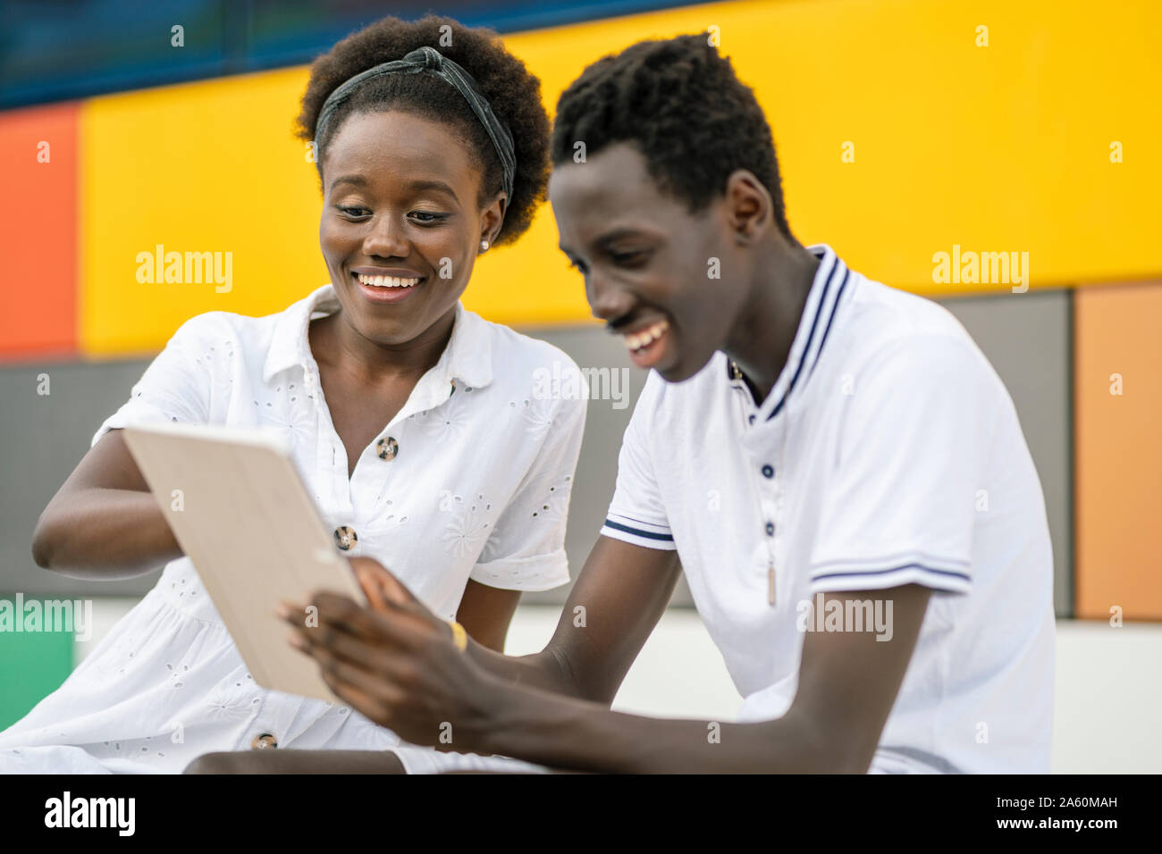 Young couple using digital tablet outdoors Stock Photo
