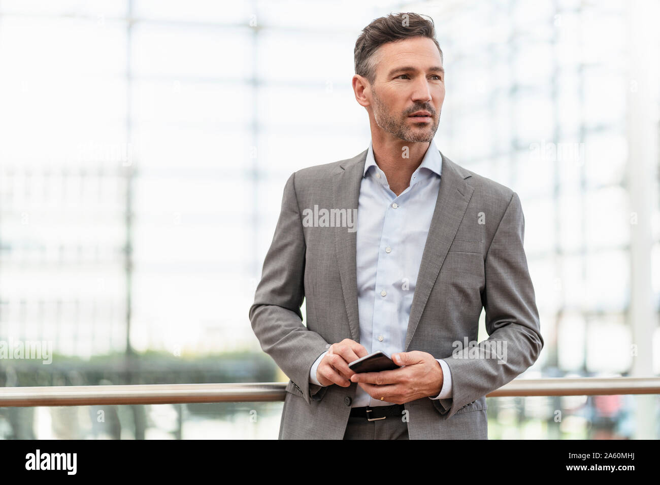 Portrait of businessman holding cell phone Stock Photo