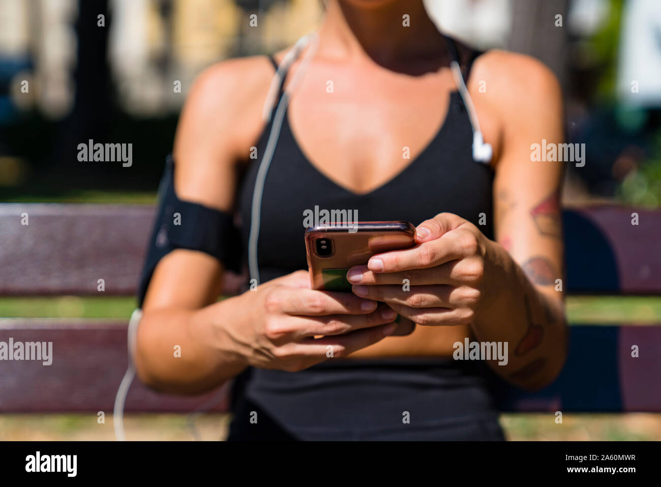 Close-up of sporty young woman holding cell phone Stock Photo