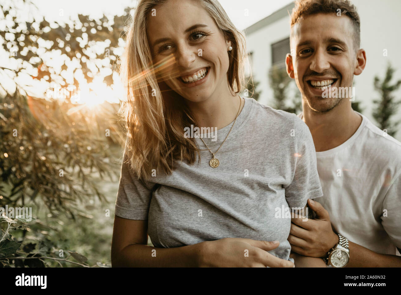 Portrait of young smiling couple a sunset Stock Photo - Alamy