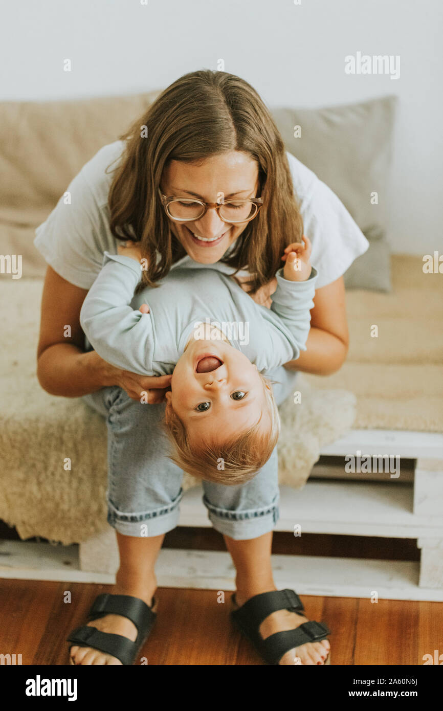Mother fooling around with her little daughter Stock Photo