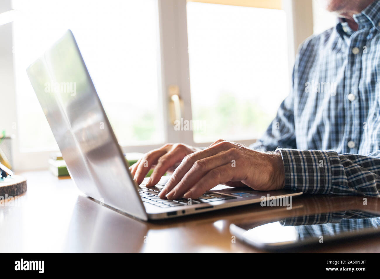 Senior man using laptop at home Stock Photo