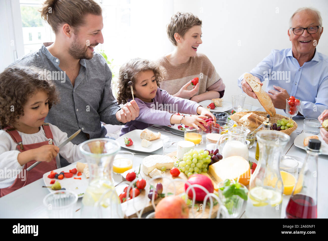 Happy extended family having lunch at home Stock Photo