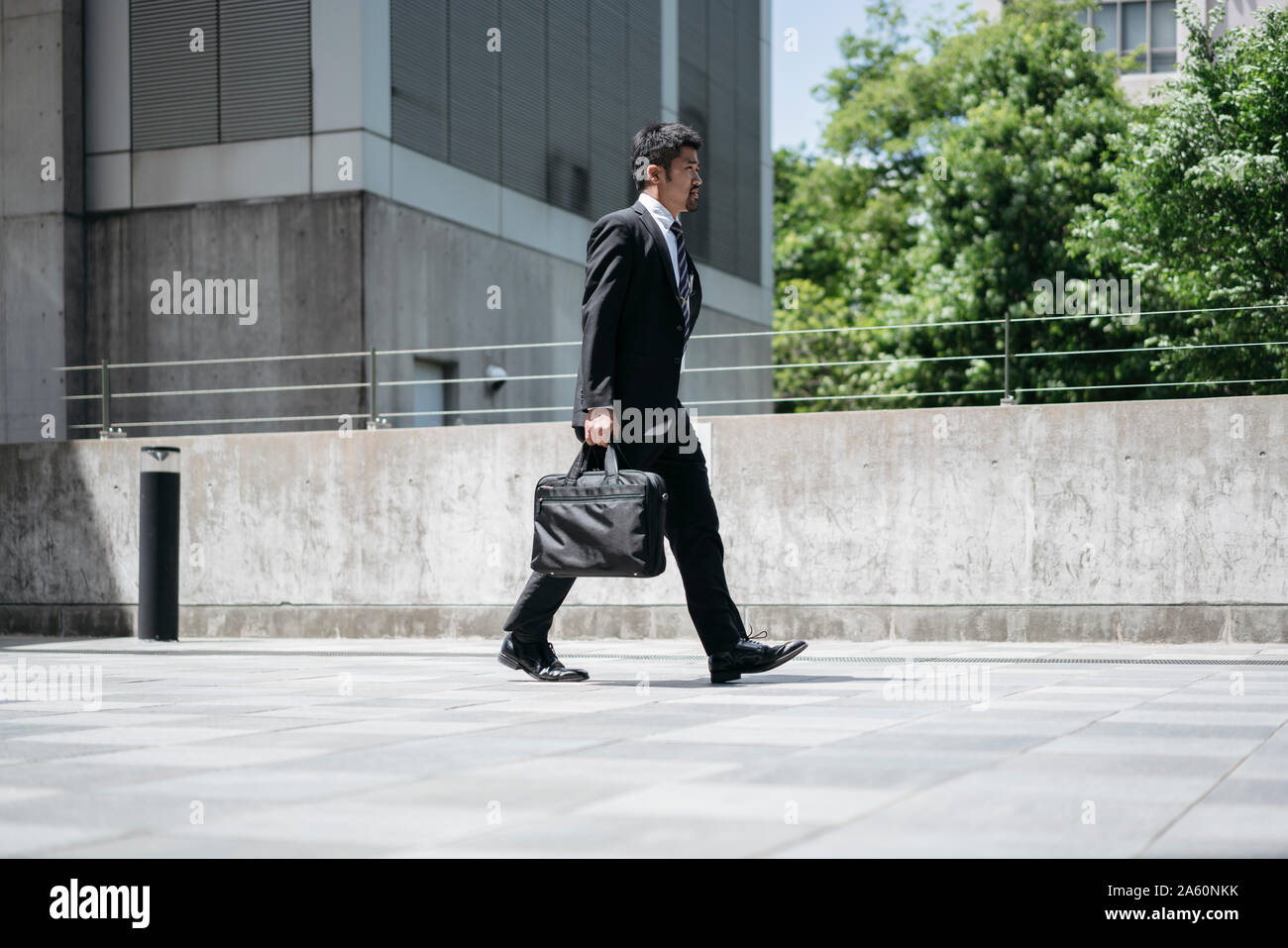 Walking young man in suit hi-res stock photography and images - Alamy