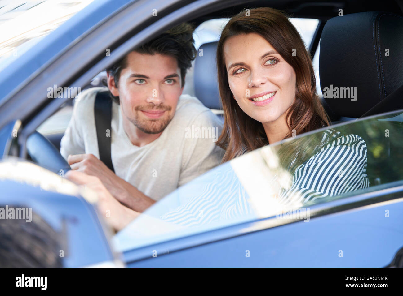 Couple in a car looking out of window Stock Photo