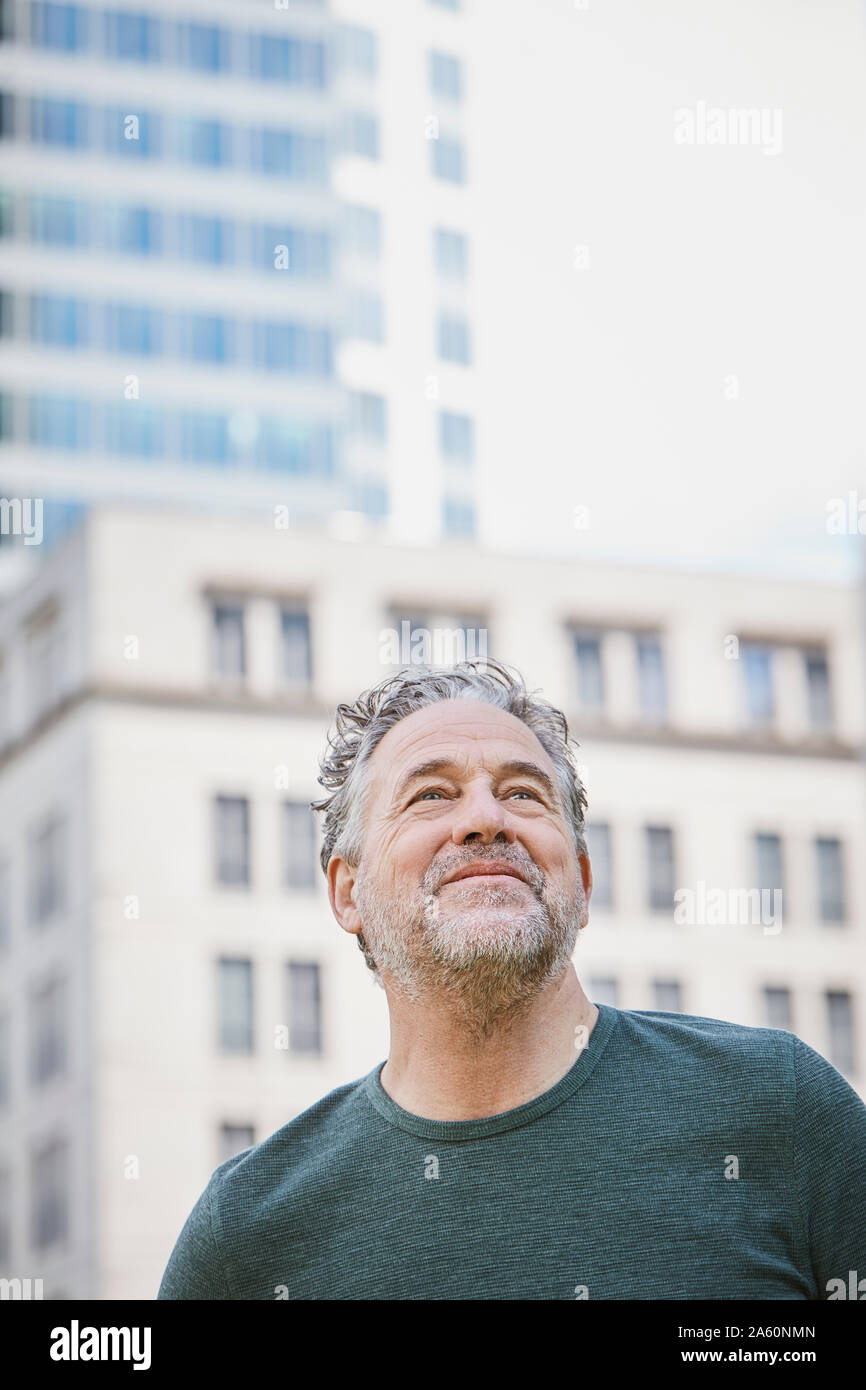 Portrait of confident mature man in the city looking up Stock Photo