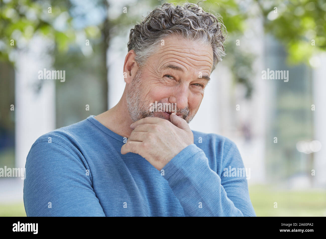 Portrait of smiling mature man in a park Stock Photo