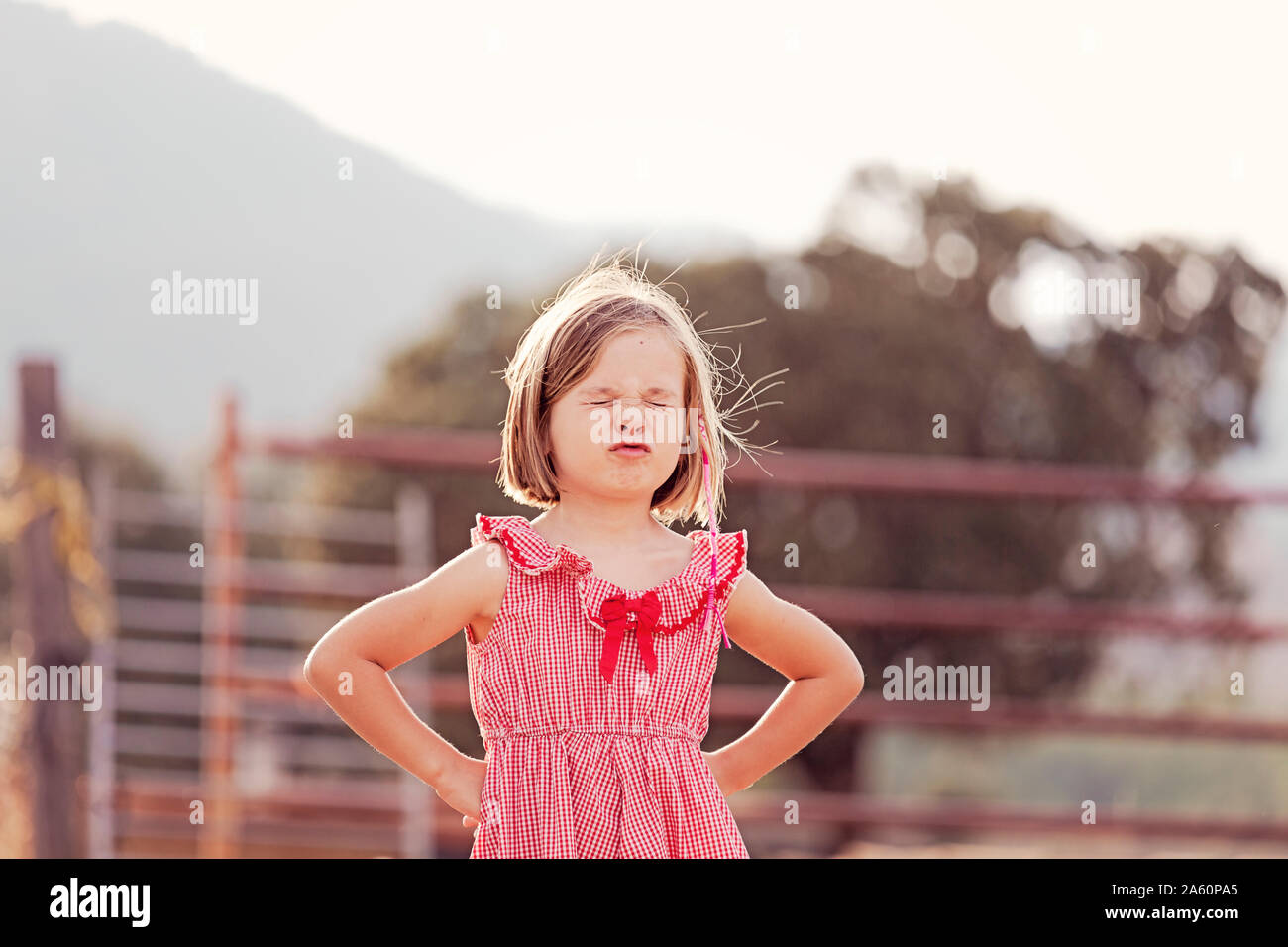 Portrait of little girl with eyes closed pouting mouth Stock Photo