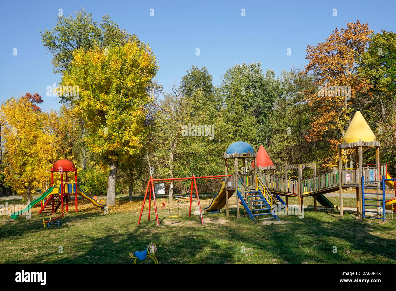 Outdoor autumn landscape with recreational playing equipment for children at Constantin Stere Park near Ploiesti , Romania Stock Photo