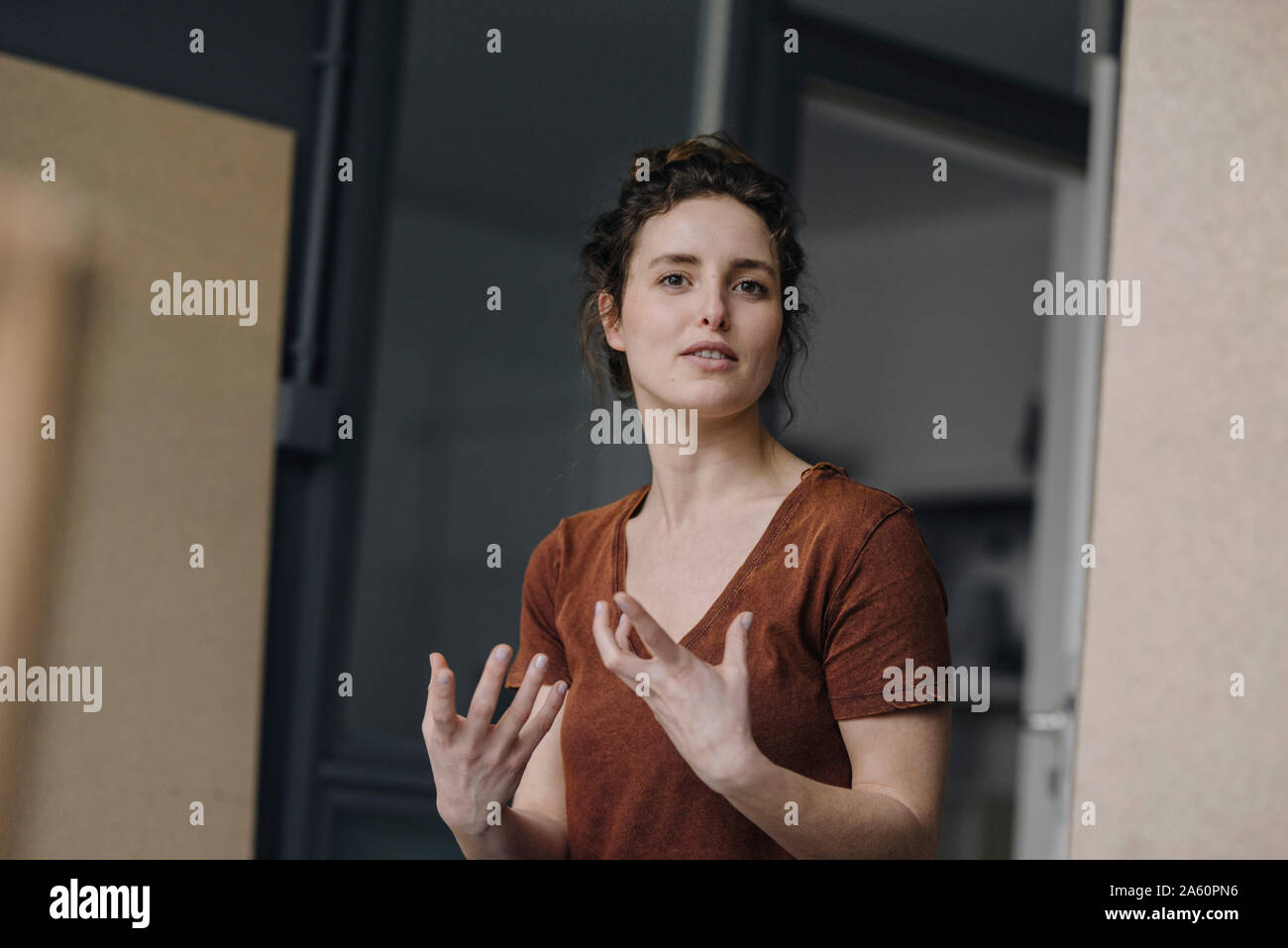Portrait of gesturing young woman Stock Photo