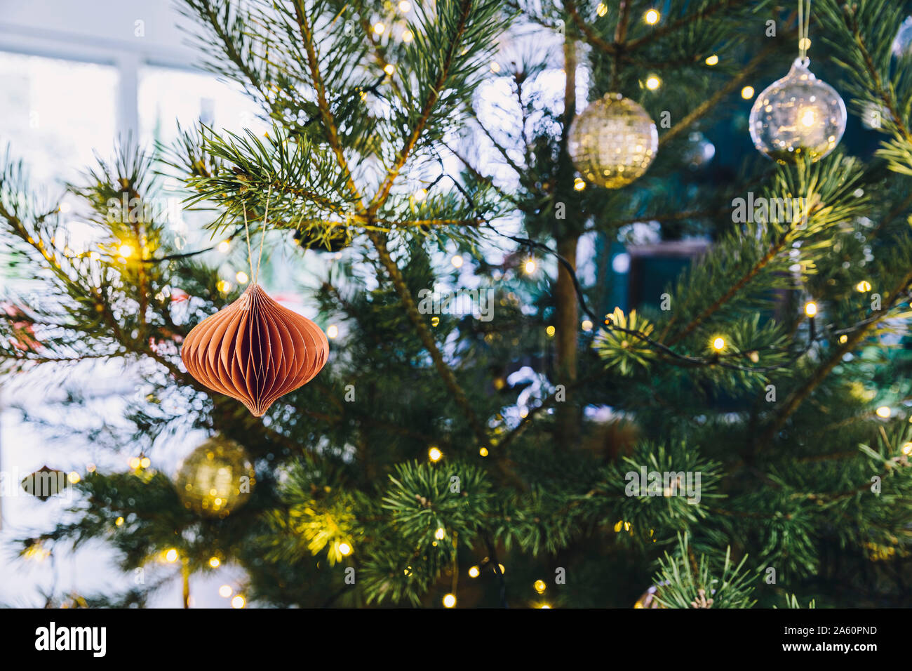 Closeup of decorated pine Christmas tree in living room Stock Photo