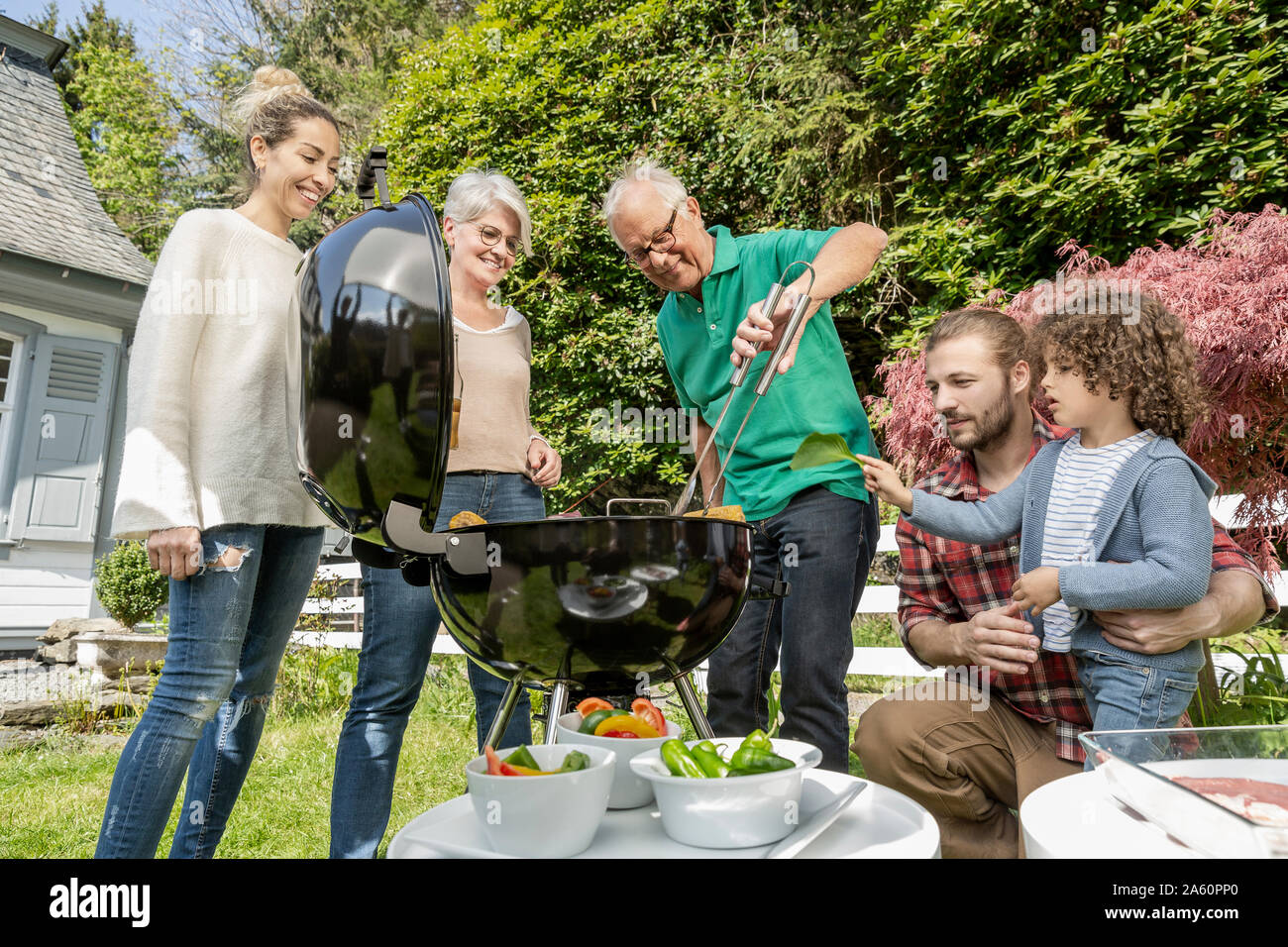 Extended family having a barbecue in garden Stock Photo