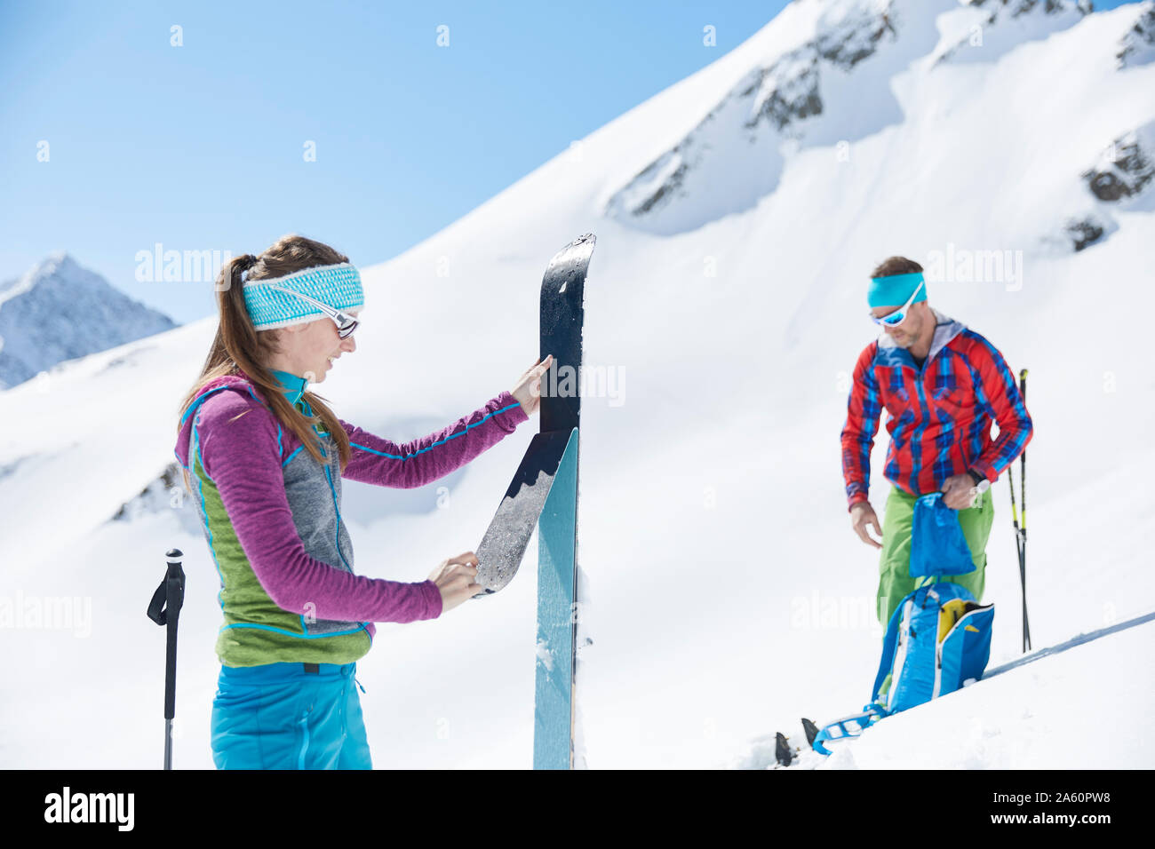 Couple of ski tourers removing pelt from ski in the mountains, Kuehtai, Tyrol, Austria Stock Photo