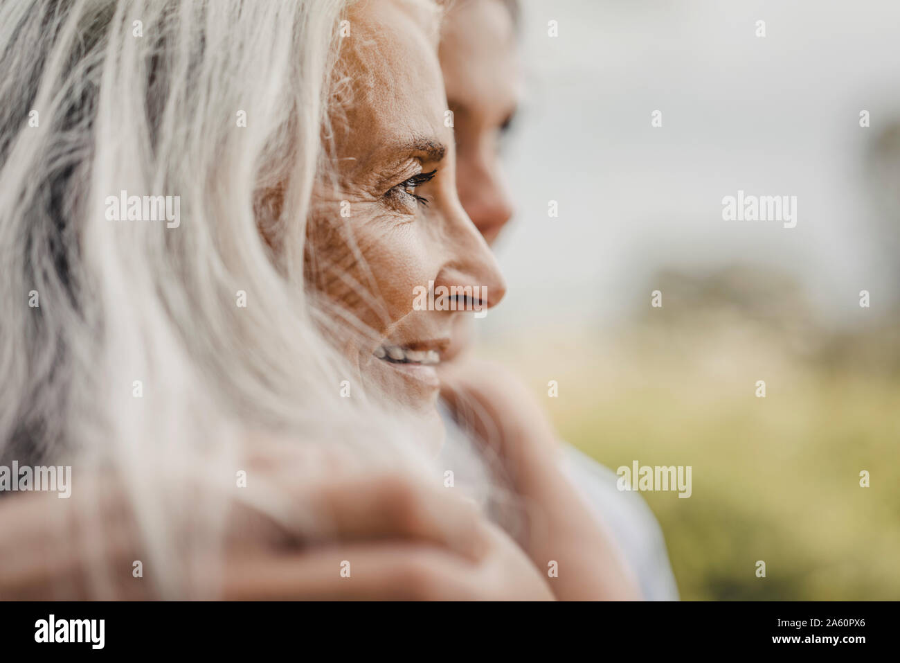 Mother and daughter embracing in nature, portrait Stock Photo