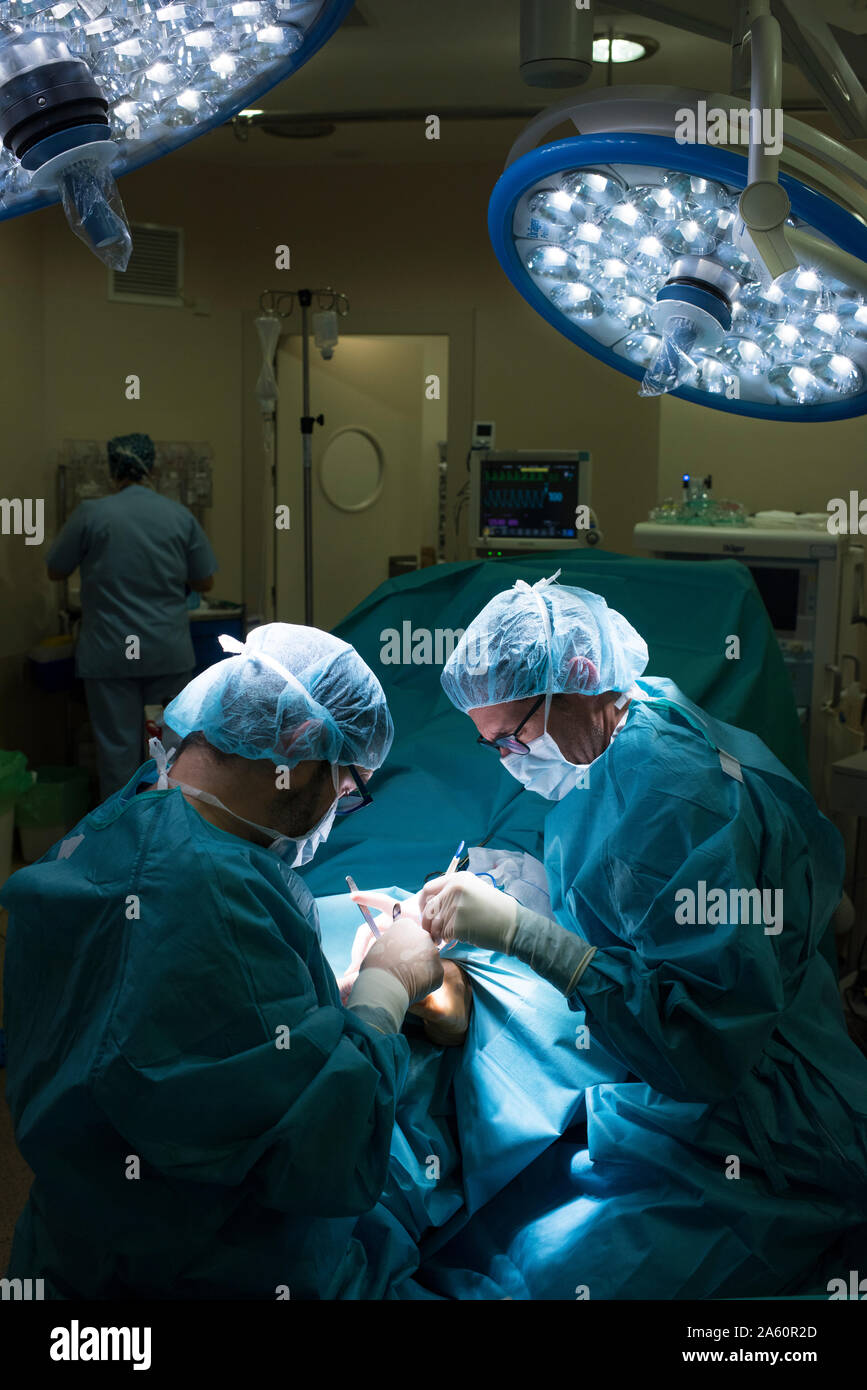 Surgeons during a foot surgery Stock Photo