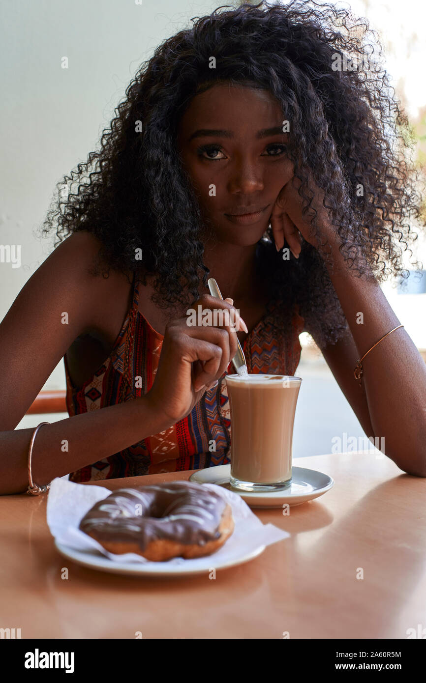 Portrait of young African woman in a cafe Stock Photo