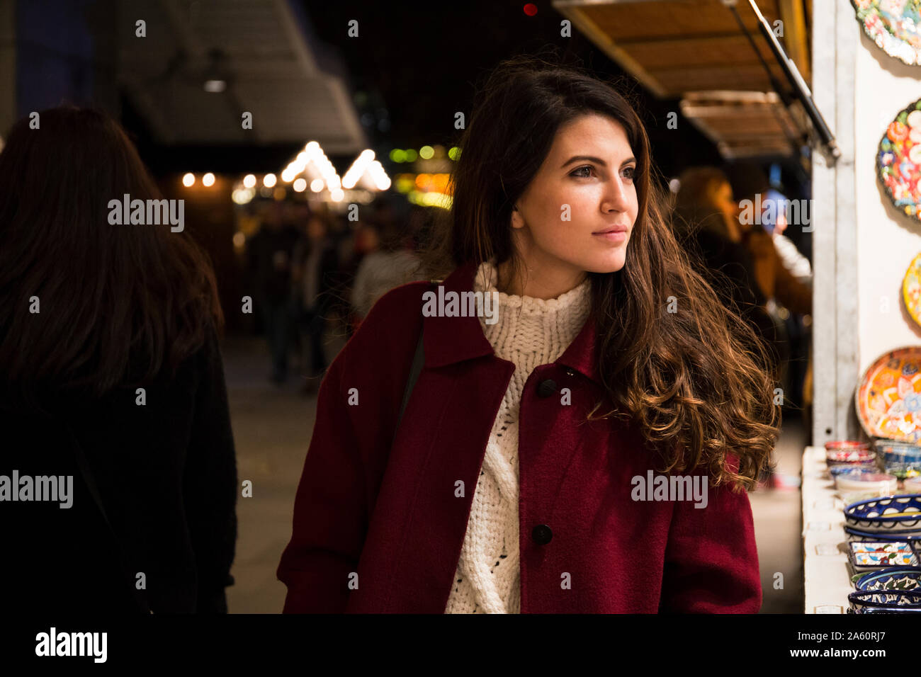 Portrait of young woman at Christmas market Stock Photo