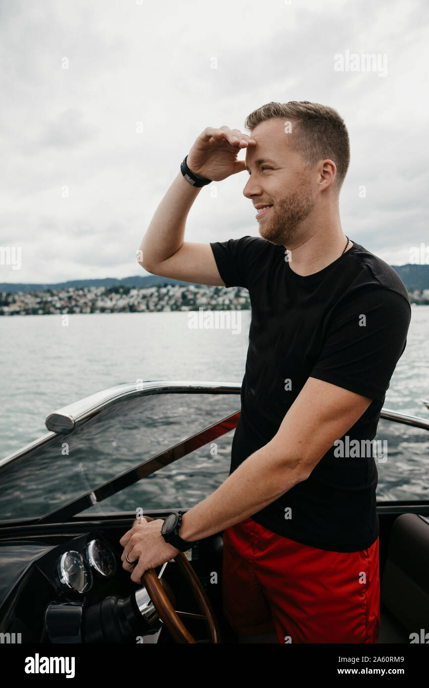 Man steering boat hi-res stock photography and images - Alamy