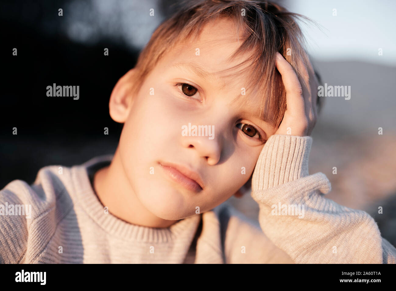 Portrait of pensive boy with head in his hand Stock Photo