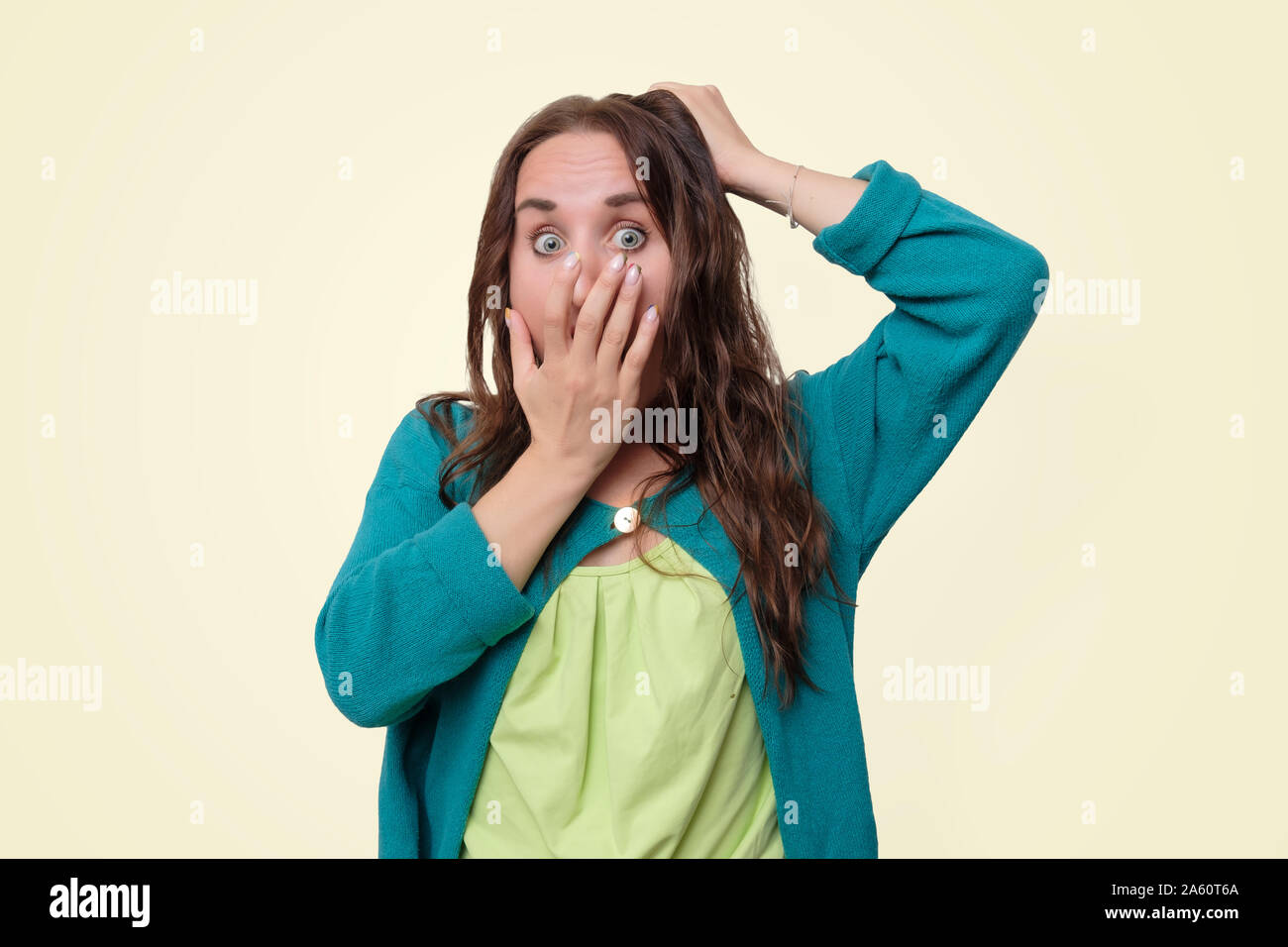 Young curly female in shock, having forgotten about important meeting Stock Photo