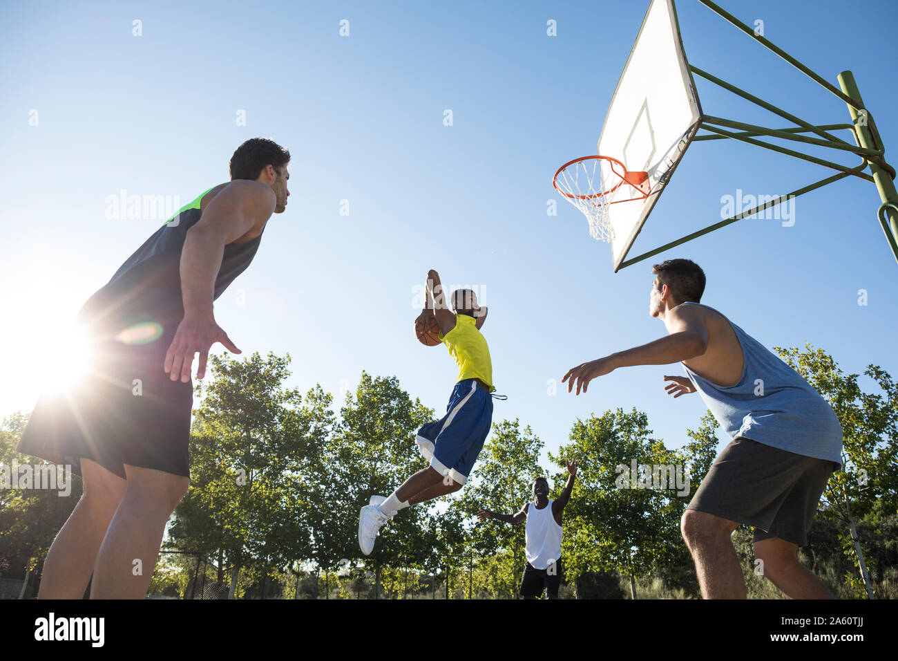 Group of people running and jumping while playing streetball Stock Photo