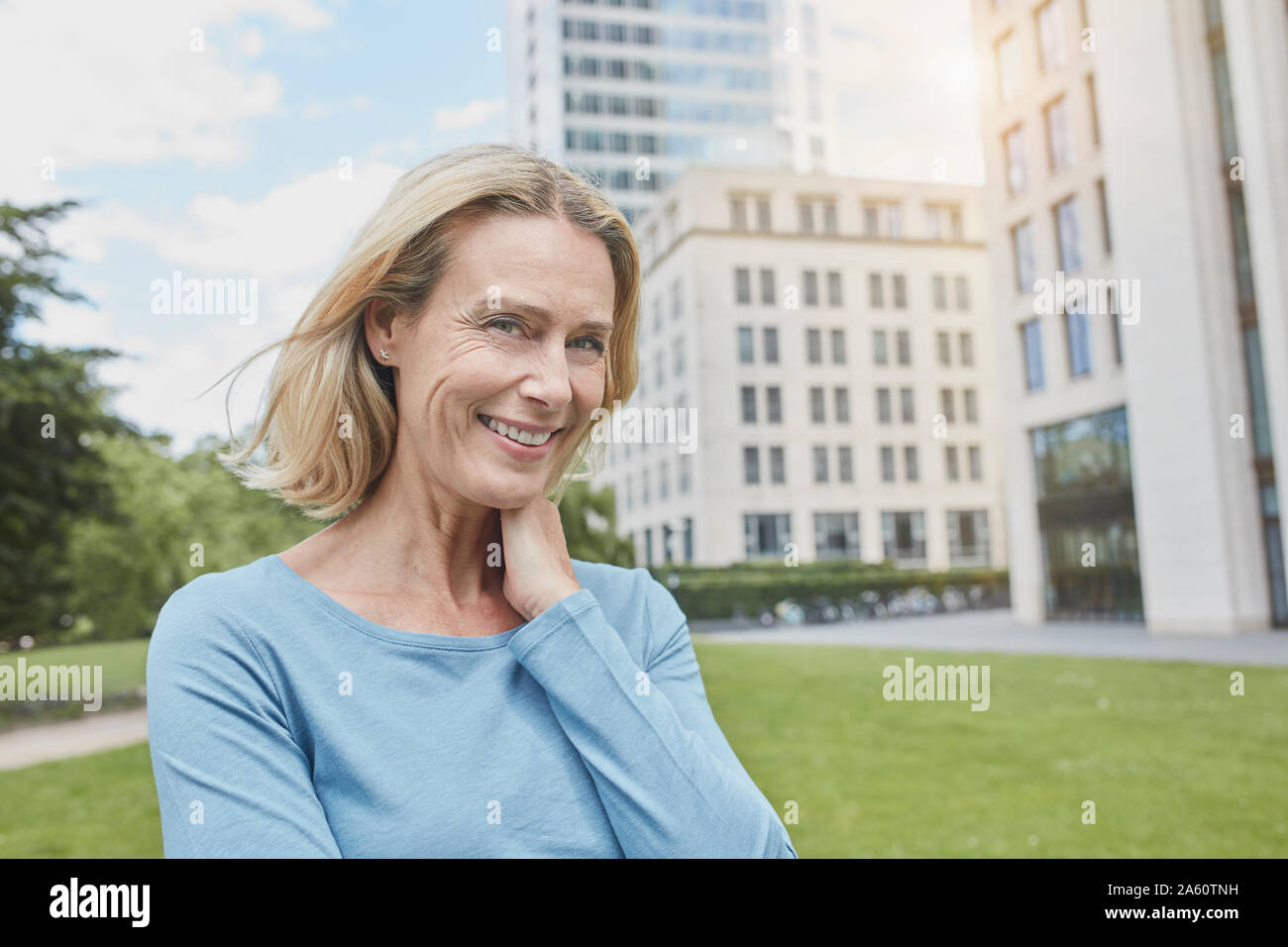 Portrait of smiling blond woman in the city Stock Photo