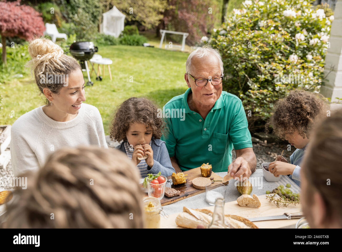 Extended family having lunch in garden Stock Photo