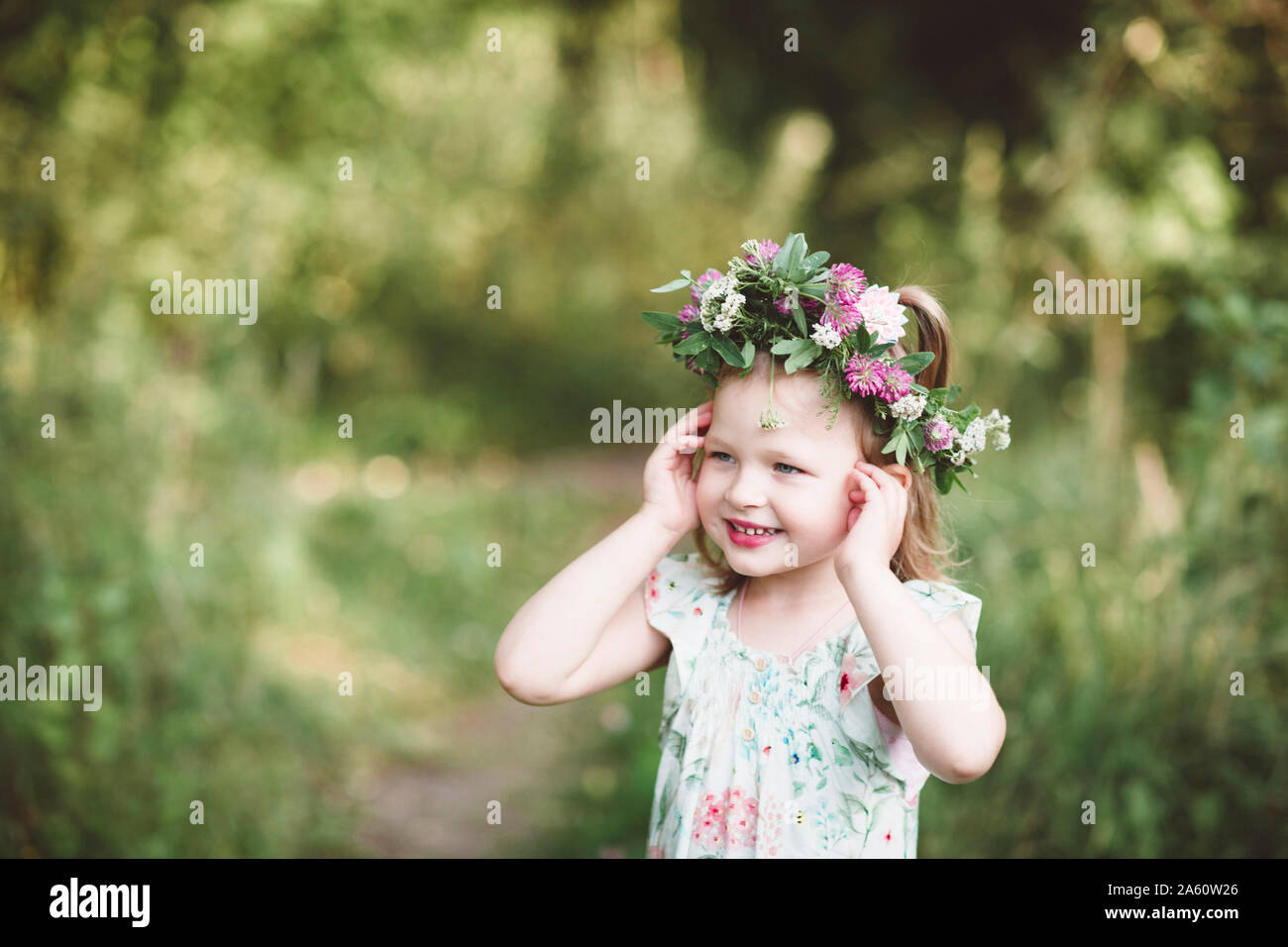 Portrait of smiling little girl with flower wreath Stock Photo - Alamy