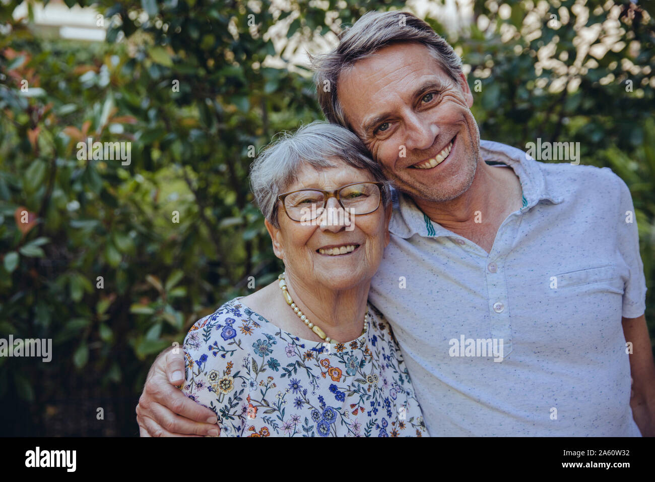 Happy mother and adult son in he garden Stock Photo