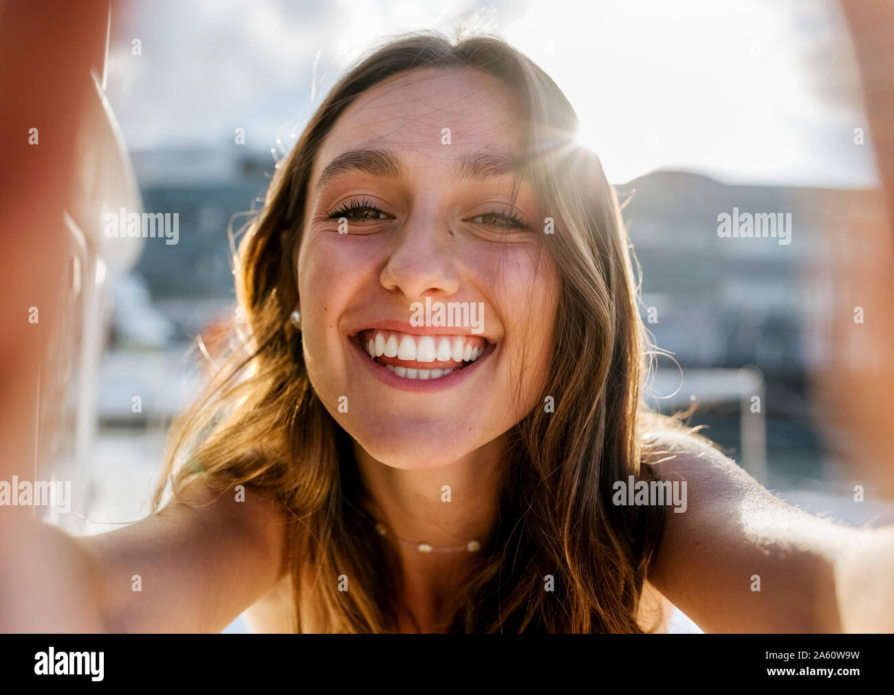Young beautiful woman taking a selfie on a sailboat Stock Photo
