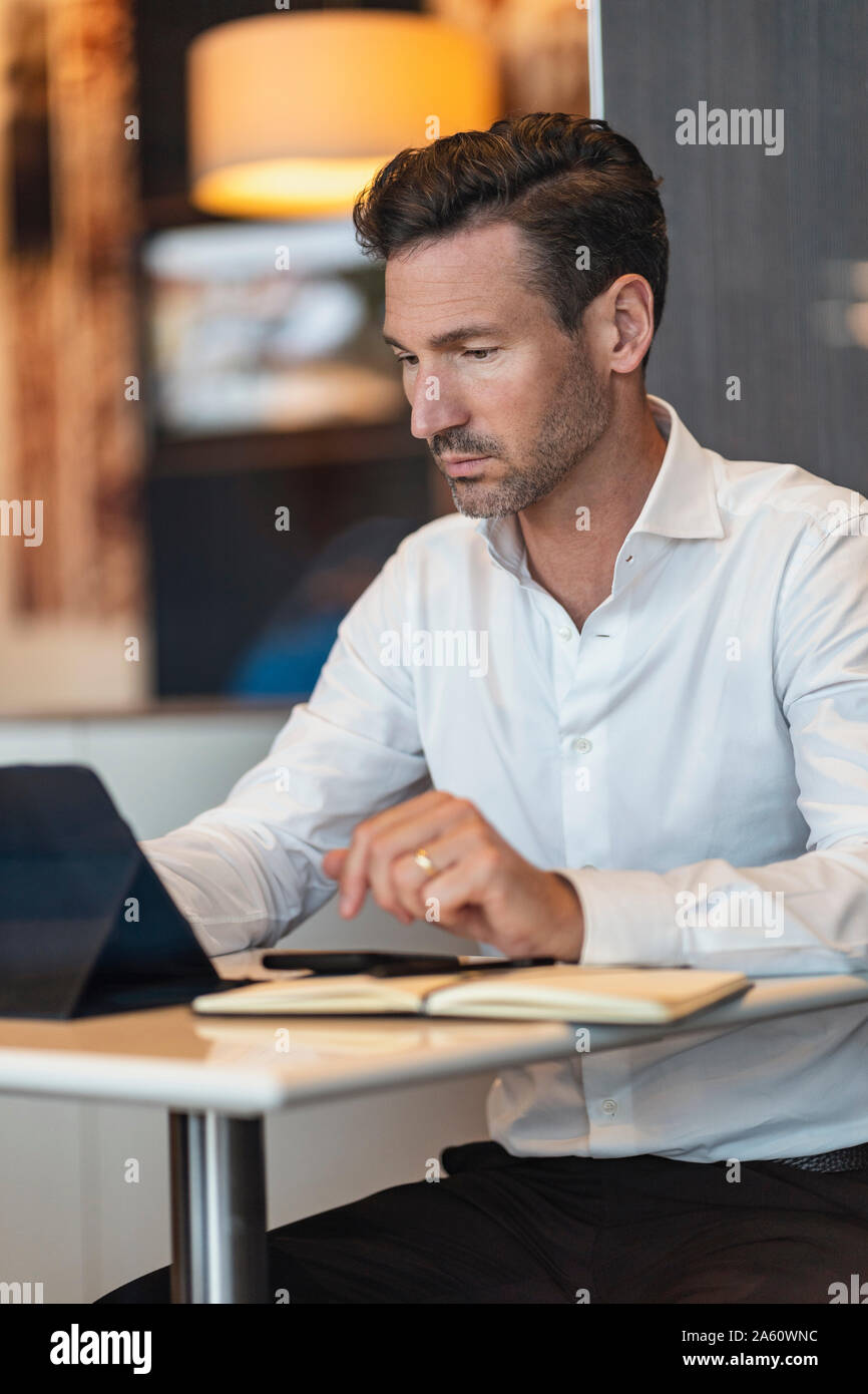 Businessman using tablet in a cafe Stock Photo